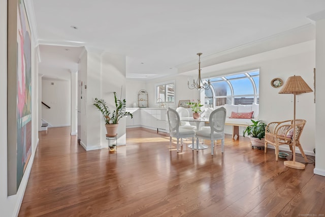 123 Harbor Dr Apt 403, Stamford, CT 06902 - dining room with ornamental molding, baseboards, wood finished floors, stairway, and a chandelier