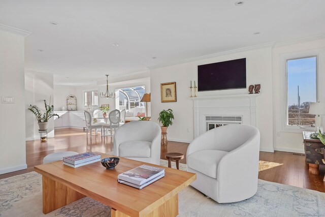 123 Harbor Dr Apt 403, Stamford, CT 06902 - living area with wood finished floors, a fireplace, crown molding, a chandelier, and baseboards