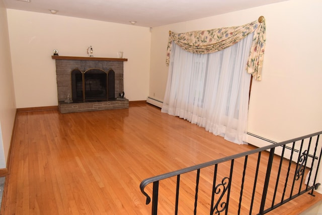 15 Valley Brook Rd, Branford, CT 06405 - living room with wood finished floors, baseboard heating, a brick fireplace, and baseboards