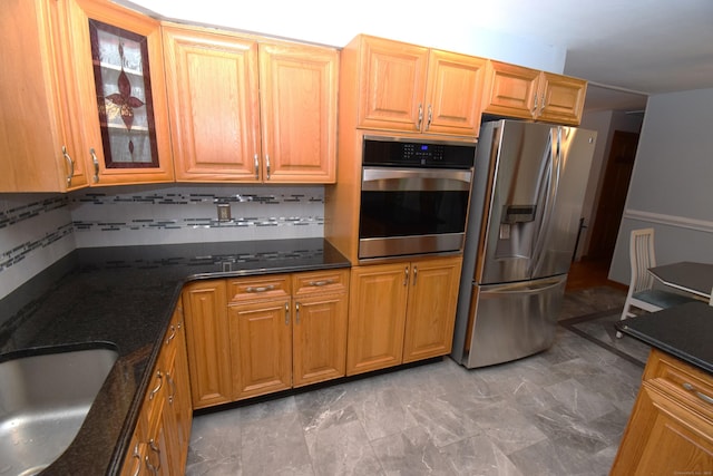 15 Valley Brook Rd, Branford, CT 06405 - kitchen with appliances with stainless steel finishes, decorative backsplash, dark stone counters, glass insert cabinets, and a sink