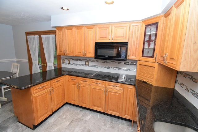 15 Valley Brook Rd, Branford, CT 06405 - kitchen featuring black appliances, decorative backsplash, a peninsula, dark stone countertops, and glass insert cabinets