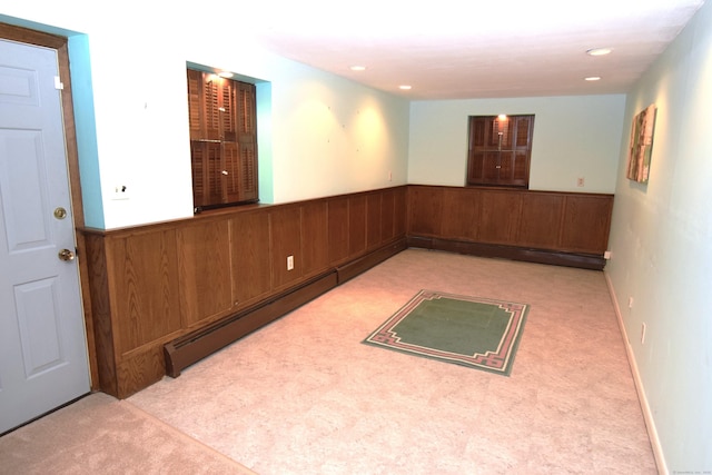 15 Valley Brook Rd, Branford, CT 06405 - empty room with carpet floors, a baseboard heating unit, a wainscoted wall, and wooden walls
