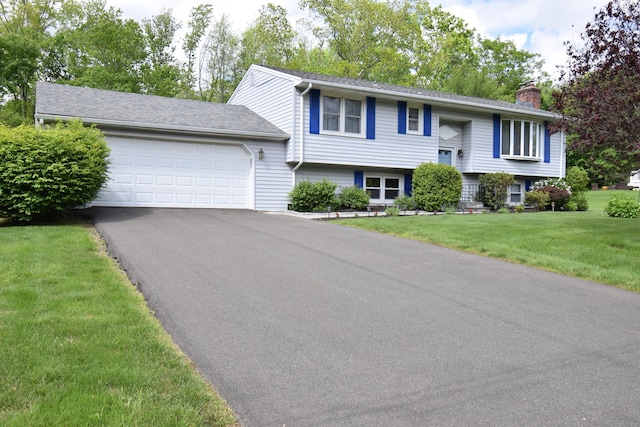 15 Valley Brook Rd, Branford, CT 06405 - raised ranch with a chimney, a garage, asphalt driveway, and a front lawn
