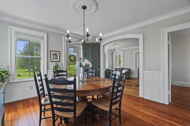 131 Elm St, Guilford, CT 06437 - dining space featuring a chandelier, a wainscoted wall, hardwood / wood-style floors, and ornamental molding