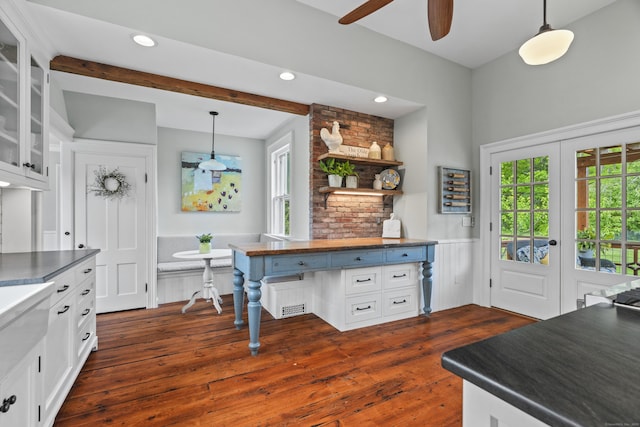 131 Elm St, Guilford, CT 06437 - kitchen featuring dark countertops, healthy amount of natural light, white cabinets, a wainscoted wall, and recessed lighting