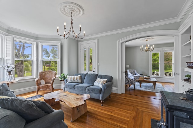 131 Elm St, Guilford, CT 06437 - living room featuring a chandelier, crown molding, and arched walkways