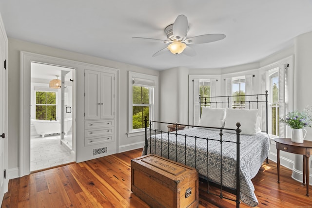 131 Elm St, Guilford, CT 06437 - bedroom with wood-type flooring, baseboards, ensuite bathroom, and ceiling fan
