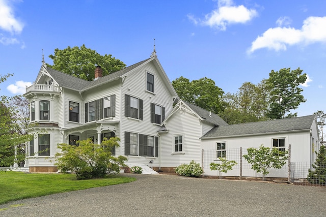 131 Elm St, Guilford, CT 06437 - victorian-style house with a chimney, roof with shingles, and a front lawn