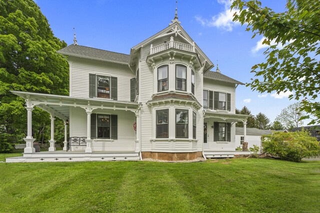 131 Elm St, Guilford, CT 06437 - view of front of house featuring a porch and a front lawn