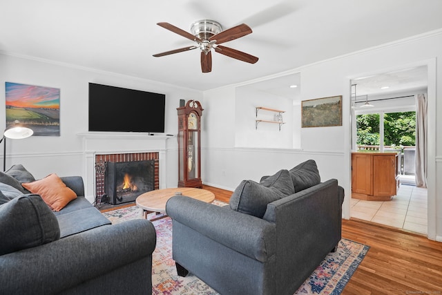 9 Waterhorse Brook Dr, Bethel, CT 06801 - living room featuring ceiling fan, crown molding, a brick fireplace, and light wood-style flooring