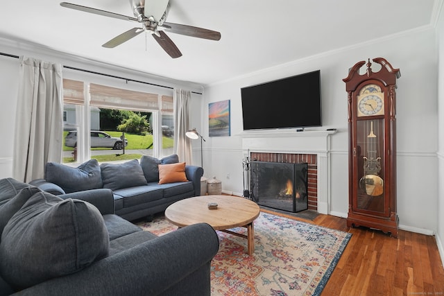 9 Waterhorse Brook Dr, Bethel, CT 06801 - living area with crown molding, a fireplace, a ceiling fan, wood finished floors, and baseboards