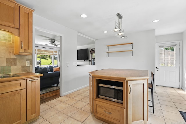 9 Waterhorse Brook Dr, Bethel, CT 06801 - kitchen with stainless steel microwave, light tile patterned floors, healthy amount of natural light, decorative backsplash, and recessed lighting