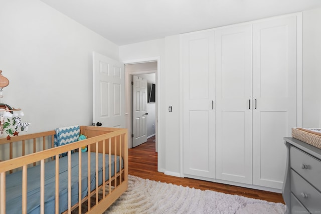 9 Waterhorse Brook Dr, Bethel, CT 06801 - bedroom with wood finished floors, a closet, and a nursery area