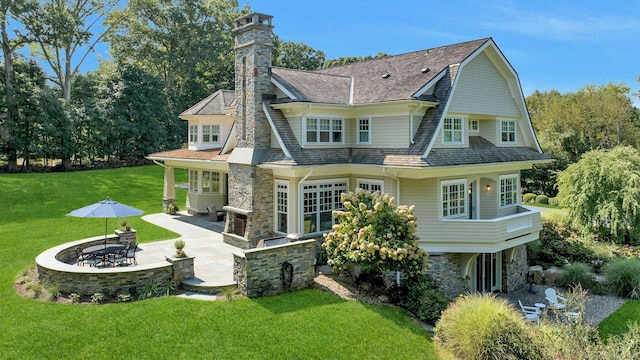 80 Compo Rd N, Westport, CT 06880 - rear view of house featuring stone siding, a patio, a lawn, and a gambrel roof