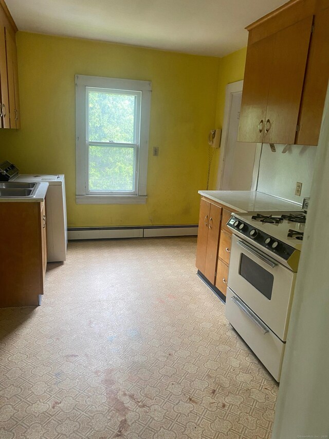 235 Long Hill Ave, Shelton, CT 06484 - kitchen featuring white range with gas cooktop, brown cabinetry, a baseboard radiator, and light countertops