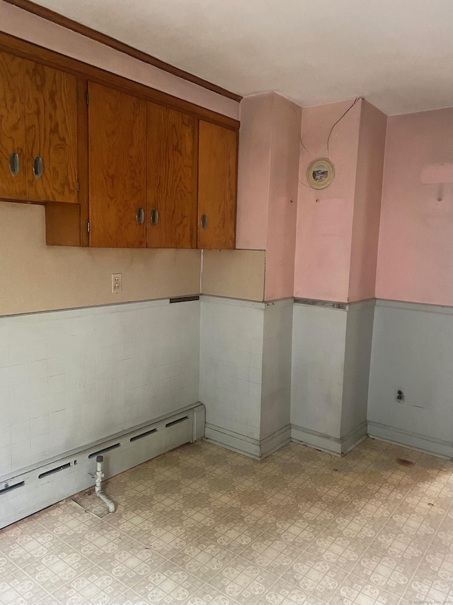 235 Long Hill Ave, Shelton, CT 06484 - spare room with baseboard heating, light flooring, and a wainscoted wall
