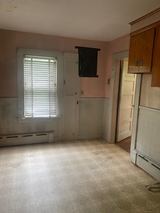 235 Long Hill Ave, Shelton, CT 06484 - spare room featuring a baseboard radiator and wainscoting