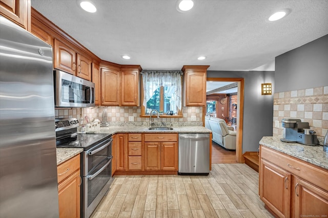 70 Birchwood Dr, Middletown, CT 06457 - kitchen featuring appliances with stainless steel finishes, a sink, light wood-type flooring, tasteful backsplash, and recessed lighting