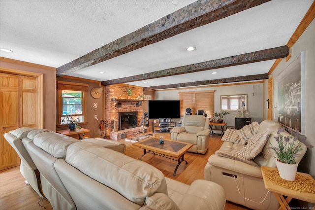 70 Birchwood Dr, Middletown, CT 06457 - living area with light wood-type flooring, beamed ceiling, a brick fireplace, a textured ceiling, and recessed lighting
