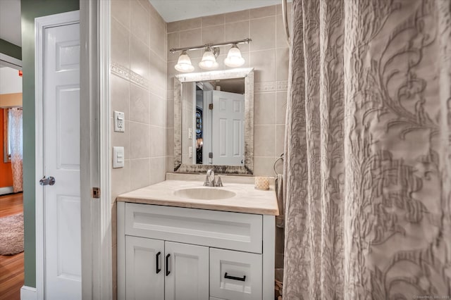 70 Birchwood Dr, Middletown, CT 06457 - bathroom featuring tile walls, vanity, and wood finished floors