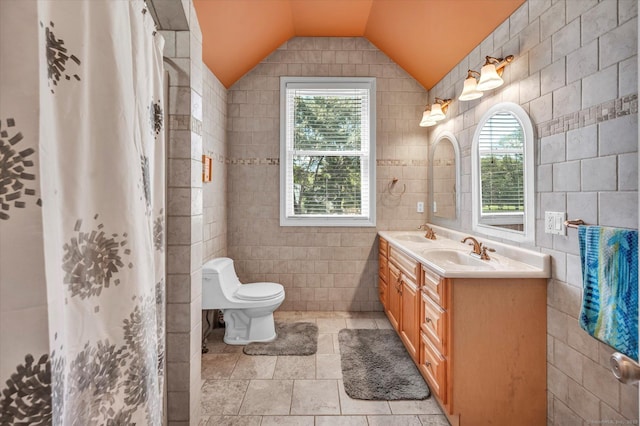 70 Birchwood Dr, Middletown, CT 06457 - bathroom featuring tile walls, double vanity, plenty of natural light, lofted ceiling, and toilet
