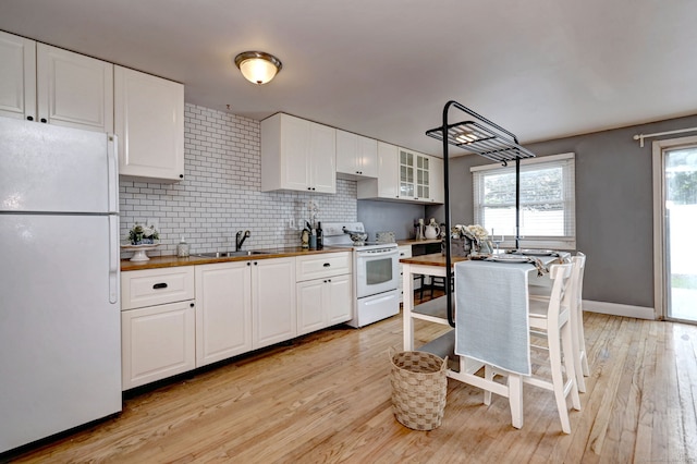190 Wooster St Unit 27, New Haven, CT 06511 - kitchen with white appliances, backsplash, white cabinets, and a sink