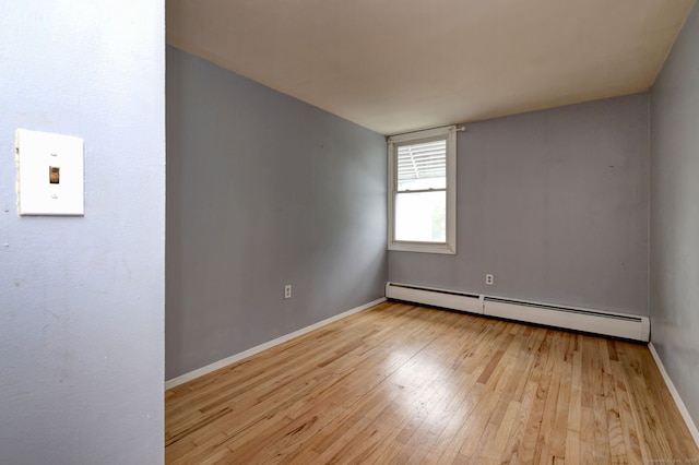 190 Wooster St Unit 27, New Haven, CT 06511 - empty room featuring a baseboard radiator, light wood-type flooring, and baseboards