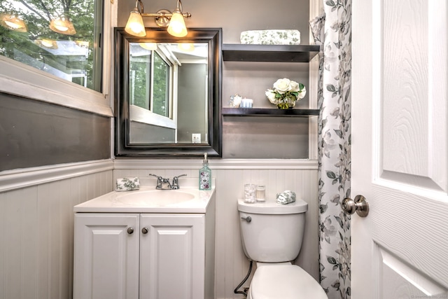 190 Wooster St Unit 27, New Haven, CT 06511 - bathroom with vanity, toilet, and a wainscoted wall
