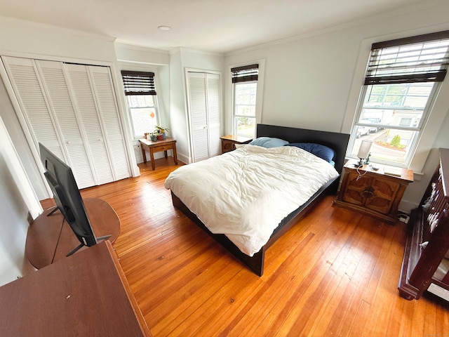124 Richards St, West Haven, CT 06516 - bedroom with multiple closets, multiple windows, light wood-style floors, and crown molding
