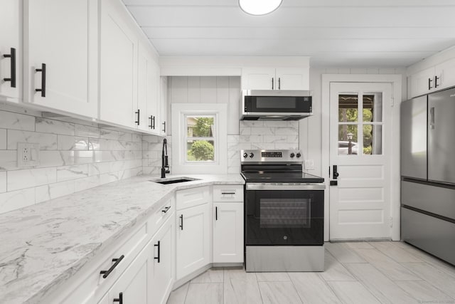 30 Buena Vista St, Farmington, CT 06085 - kitchen with appliances with stainless steel finishes, a sink, tasteful backsplash, and white cabinetry