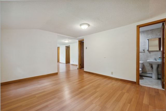 49 Longwood Dr, East Haddam, CT 06415 - spare room featuring light wood-type flooring, baseboards, a baseboard heating unit, and a sink