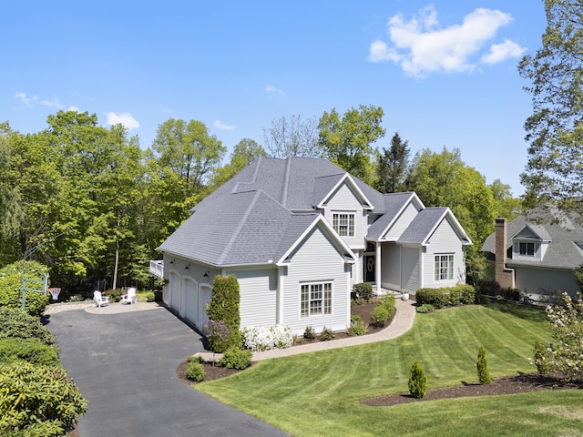 35 Bart Dr, Canton, CT 06019 - traditional-style home with asphalt driveway, a front lawn, a shingled roof, and an attached garage