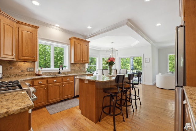 35 Bart Dr, Canton, CT 06019 - kitchen featuring stainless steel appliances, ornamental molding, a sink, a kitchen island, and light wood finished floors