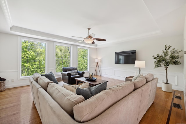 35 Bart Dr, Canton, CT 06019 - living area with a tray ceiling, plenty of natural light, ceiling fan, wood finished floors, and wainscoting