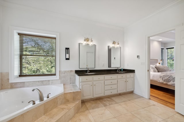 35 Bart Dr, Canton, CT 06019 - ensuite bathroom featuring double vanity, crown molding, a jetted tub, and tile patterned flooring