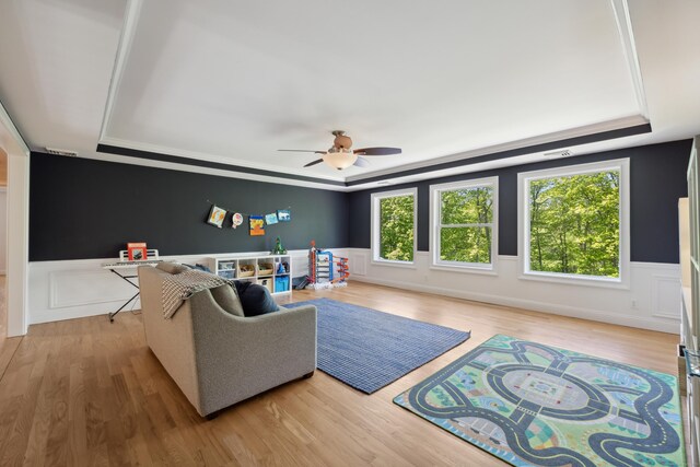35 Bart Dr, Canton, CT 06019 - living area featuring a tray ceiling, wood finished floors, wainscoting, ceiling fan, and ornamental molding
