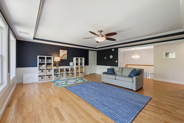 35 Bart Dr, Canton, CT 06019 - living room featuring a ceiling fan, wood finished floors, wainscoting, crown molding, and a decorative wall