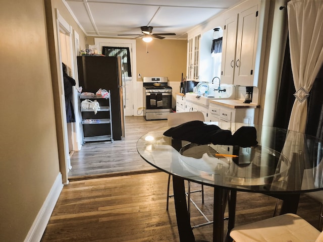 80 N St, Windham, CT 06226 - kitchen featuring appliances with stainless steel finishes, white cabinetry, a ceiling fan, and light wood-style flooring
