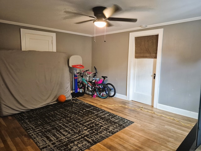 80 N St, Windham, CT 06226 - unfurnished bedroom with wood finished floors, baseboards, crown molding, and a ceiling fan