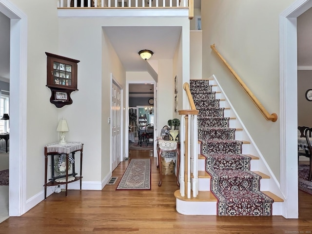 16 Trevor Ln, East Granby, CT 06026 - foyer entrance featuring wood finished floors, stairway, and baseboards