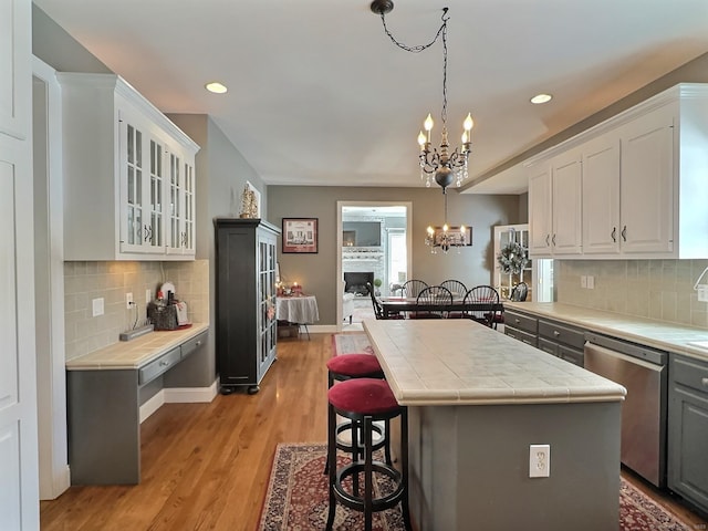 16 Trevor Ln, East Granby, CT 06026 - kitchen with stainless steel dishwasher, a chandelier, tile counters, white cabinetry, and recessed lighting