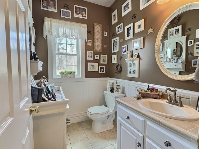 16 Trevor Ln, East Granby, CT 06026 - bathroom with tile patterned floors, toilet, a wainscoted wall, and vanity