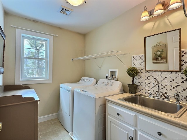 16 Trevor Ln, East Granby, CT 06026 - laundry room with washing machine and dryer, cabinet space, light tile patterned floors, and baseboards