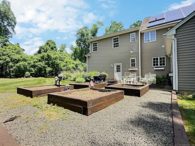 16 Trevor Ln, East Granby, CT 06026 - back of property with a garden and a lawn