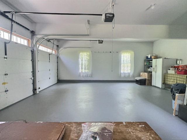 16 Trevor Ln, East Granby, CT 06026 - garage with white refrigerator with ice dispenser and a garage door opener