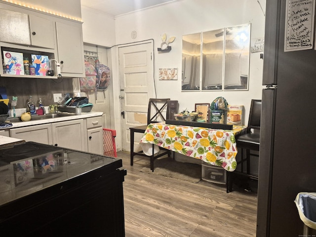 96 S St, Windham, CT 06226 - kitchen featuring freestanding refrigerator, light wood finished floors, light countertops, and black electric range