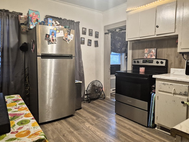 96 S St, Windham, CT 06226 - kitchen with stainless steel appliances, wood finished floors, light countertops, ornamental molding, and white cabinetry