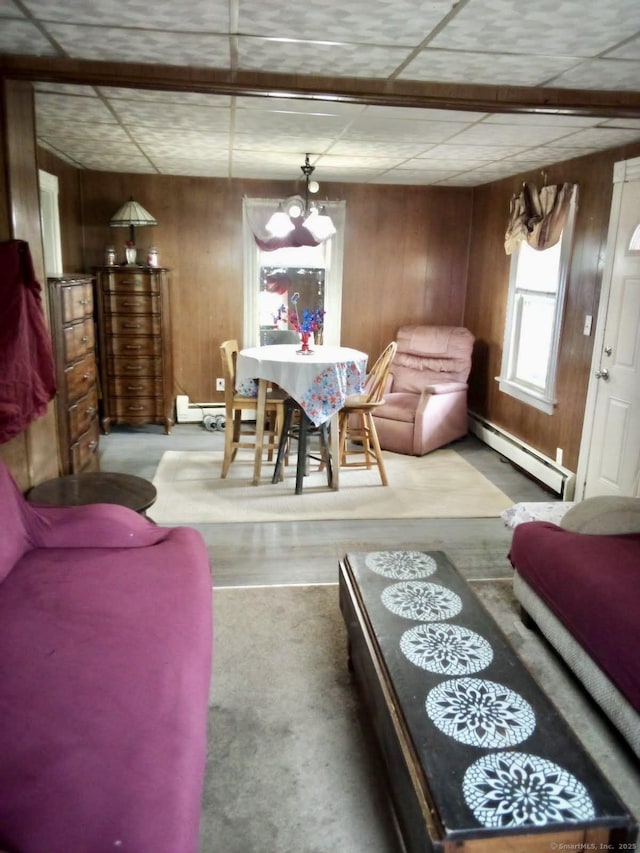 100 Roosevelt Ave, Torrington, CT 06790 - living area with a baseboard radiator, wooden walls, and wood finished floors