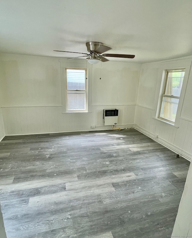 100 Roosevelt Ave, Torrington, CT 06790 - empty room with heating unit, ceiling fan, wainscoting, wood finished floors, and a decorative wall