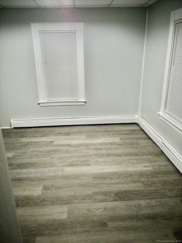 100 Roosevelt Ave, Torrington, CT 06790 - empty room with wood finished floors and a baseboard radiator